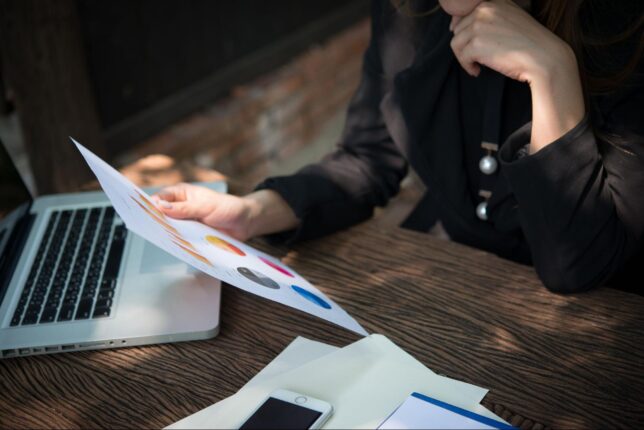 kobieta przeglądająca wykresy prezentujące zebrane dane